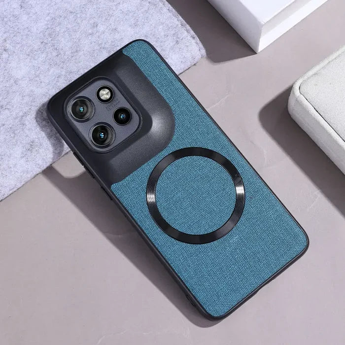 Teal fabric phone case with a black camera module and a circular magnetic ring.