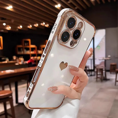 White and rose gold iPhone case with a heart cutout.