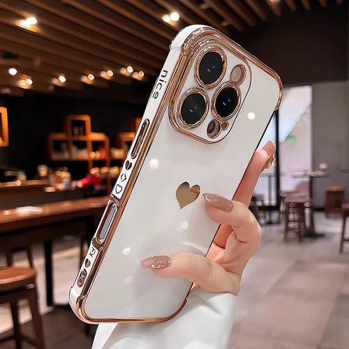 White and rose gold iPhone case with a heart cutout.