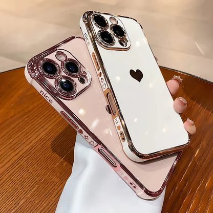 Two rose gold and white iPhone cases with heart designs.