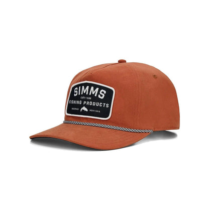 Rust-colored Simms cotton twill rope cap with a black and white rectangular logo patch on the front.
