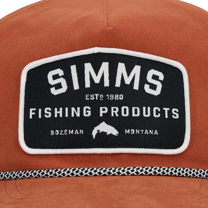 Rust-colored cotton twill rope cap featuring a black Simms Fishing Products patch with white text and fish logo.