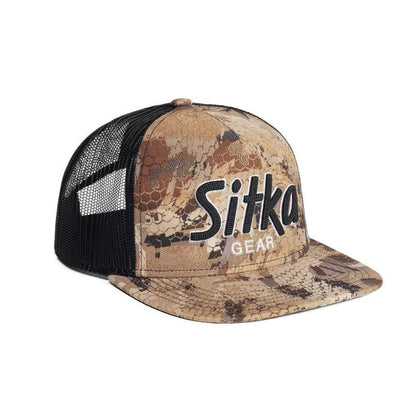 Sitka 90's Script Hi Pro trucker cap in Optifade camo with a black mesh back and embroidered vintage logo.