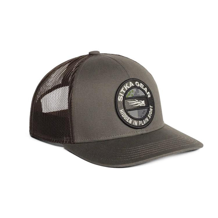Grey Sitka Gear trucker cap with mesh back, structured mid-pro fit, and circular logo featuring Optifade camo accents.