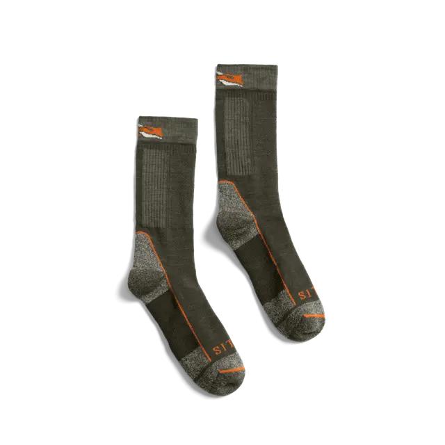 Olive green Sitka mid-weight merino wool crew socks with reinforced grey heels and toes and orange logo detailing.