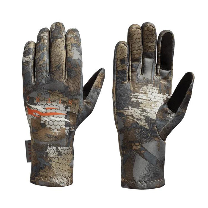 Sitka Traverse gloves in camo print with touchscreen-compatible fingertips and silicone palm grip.