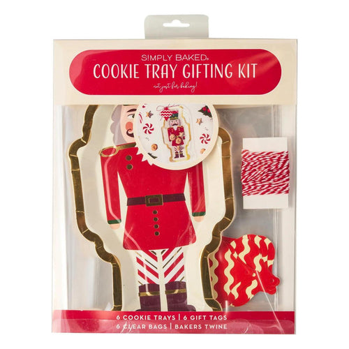 Nutcracker-shaped paper cookie trays with red and white gift tags, clear bags, and red-and-white bakers twine in a kit.