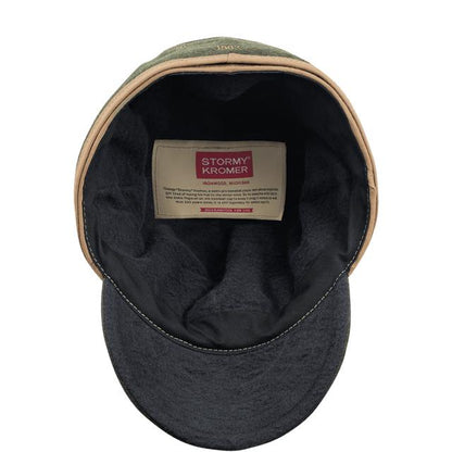 Interior view of an olive green Stormy Kromer wool cap showing the cotton flannel lining and branded label.