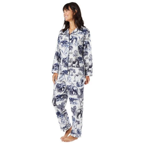 Woman wearing a blue and white elephant print Pima cotton long-sleeve pajama set with contrast piping.