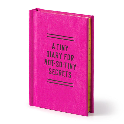 The Brass Monkey Tiny Diary for Not So Tiny Secrets is a small, bright pink hardbound diary with its name in black on the cover and features lined, gold-edged pages inside.