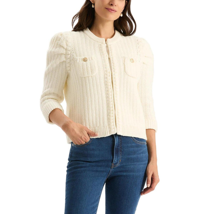 Cream cotton-blend knit jacket with puffed sleeves, gold button accents, and front patch pockets.