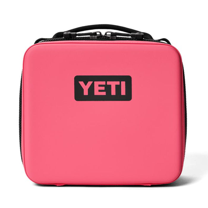 Bright pink YETI Daytrip 3L insulated lunch box with a black logo, rugged water-resistant shell, and top carry handle.