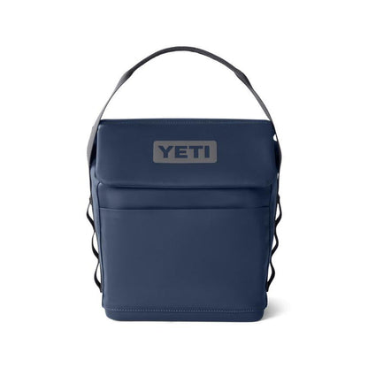 Navy blue YETI Daytrip 6L insulated lunch bag with a top handle, MagSnap closure, and front pocket on a white background.