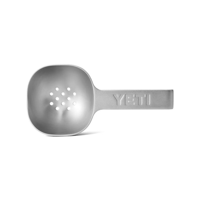 Durable stainless steel YETI ice scoop featuring a perforated base for drainage and an embossed handle logo.