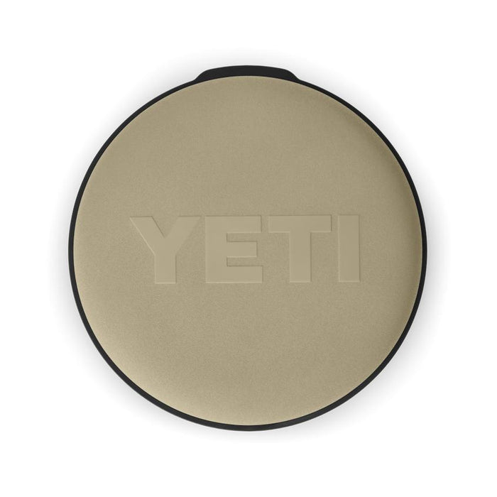 Tan YETI Loadout padded swivel seat with a circular, weather-resistant design and embossed logo on a white background.
