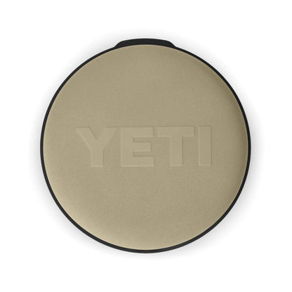 Tan YETI Loadout padded swivel seat with a circular, weather-resistant design and embossed logo on a white background.