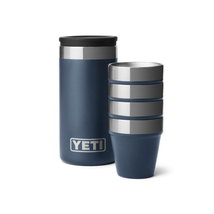Navy blue YETI shot glass set with four stackable stainless steel cups and a matching rugged carrying case.