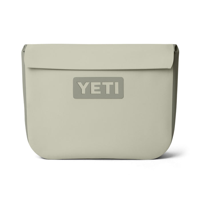 YETI Sidekick Dry 6L waterproof gear case in tan featuring a magnetic closure and durable RF-welded seams.