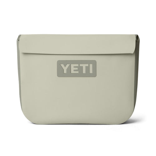 YETI Sidekick Dry 6L waterproof gear case in tan featuring a magnetic closure and durable RF-welded seams.