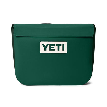 YETI Sidekick Dry 6L gear case in dark green with a waterproof magnetic seal and white brand logo on the front.