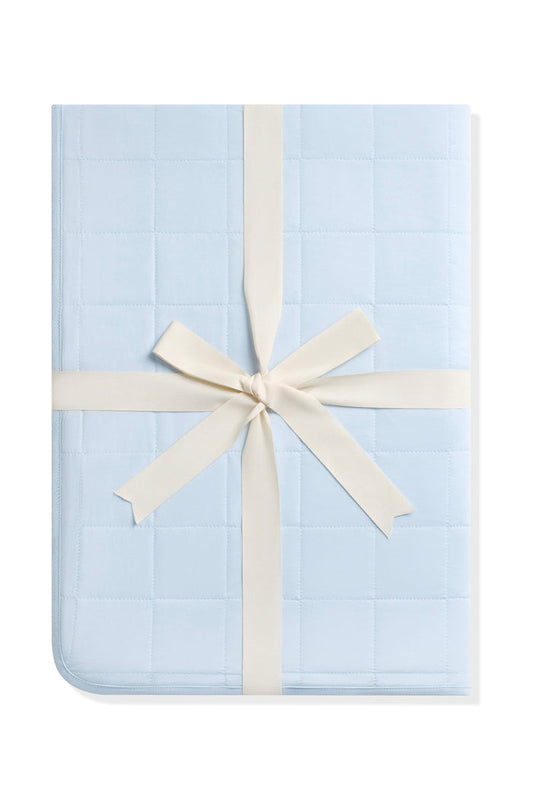 Youth Blanket in Breeze 1.0 shown in its packaging tied with a linen bow