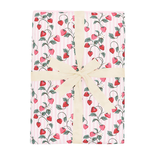 Youth Blanket in Strawberry Fields 2.5 shown in its packaging tied with a linen bow
