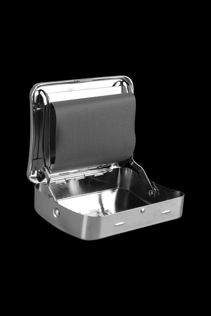 Angled close-up of the open Zen Metal Auto-Roll Box showing its shiny metal interior and black roll strap against a black background